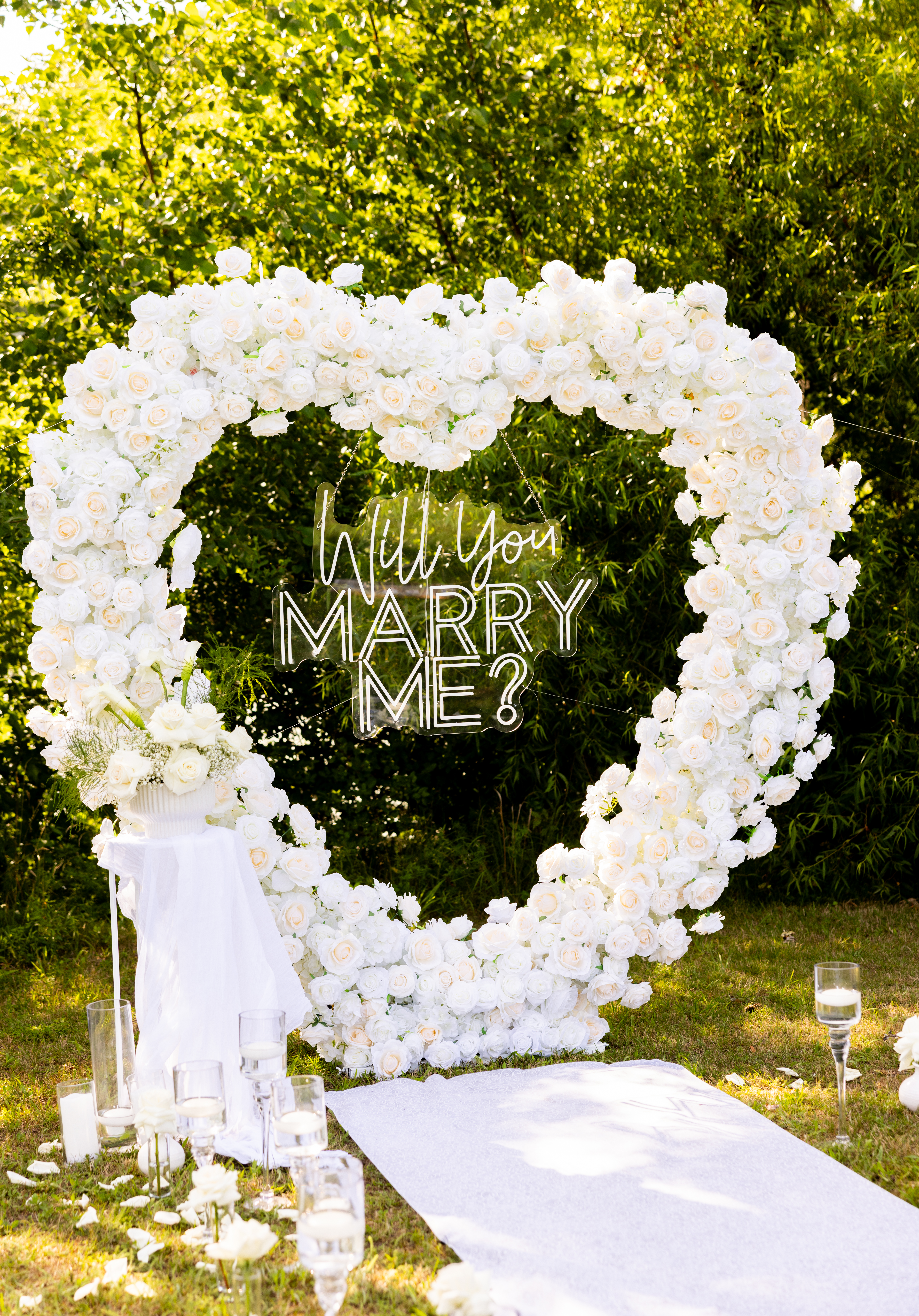Romantic proposal setup in Edison NJ with candles, flowers, and backdrop